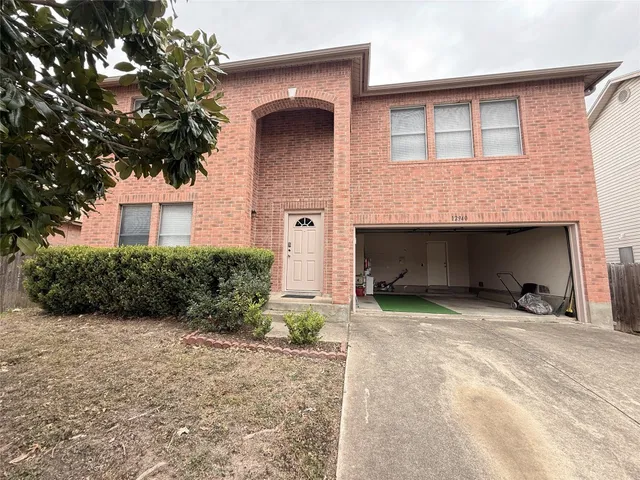 a front view of a house with yard and garage
