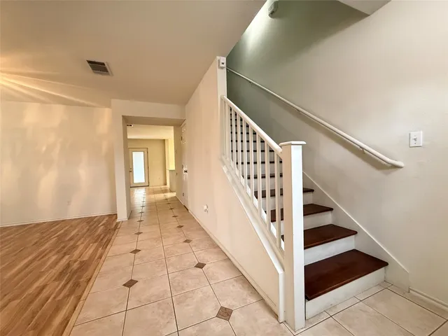 a view of staircase with white walls and railing