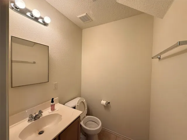 a bathroom with a sink mirror and toilet