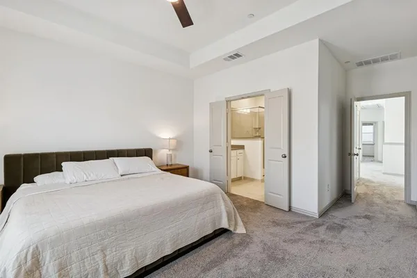 a bedroom with a bed and a view of bathroom