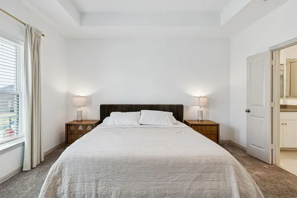a bedroom with a bed and a large mirror