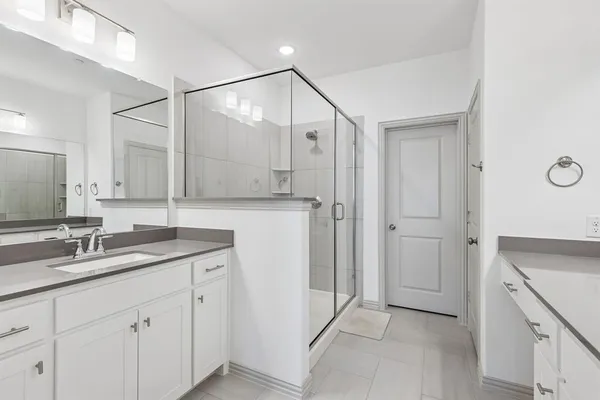 a spacious bathroom with a granite countertop sink mirror and double