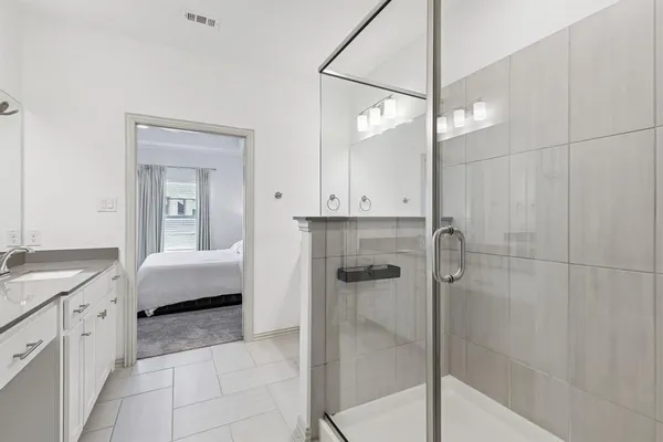 a en suite bathroom with a tub shower and sink