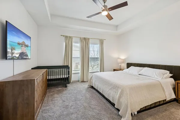 a bedroom with a large bed and a window