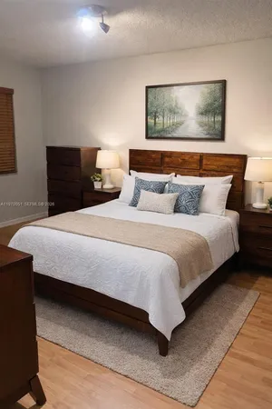 a bedroom with bed and paintings on the wall