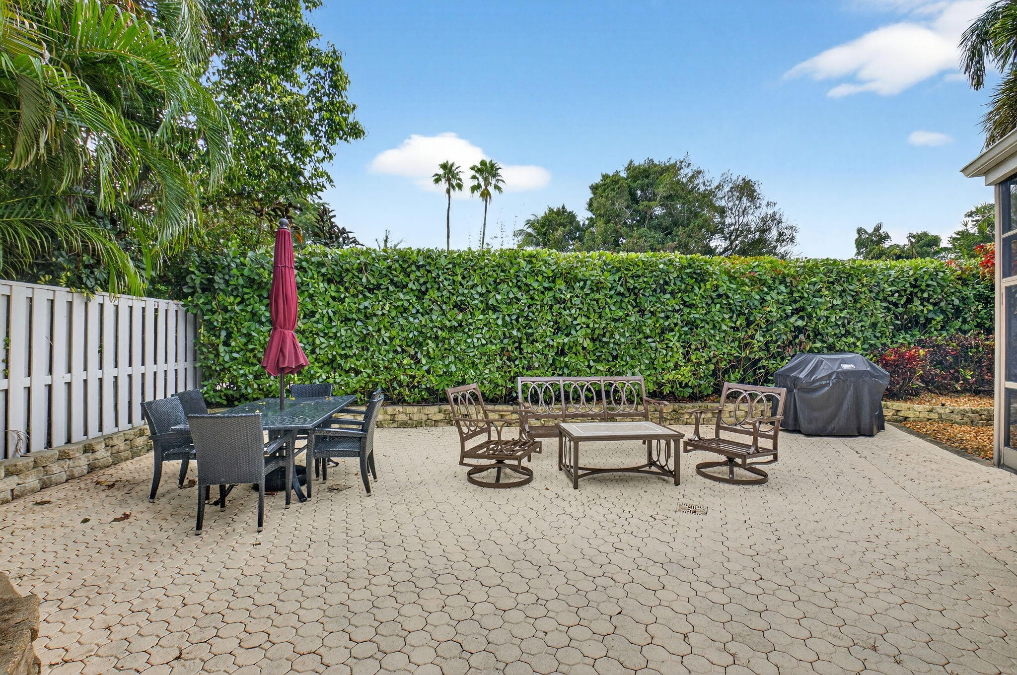 2462 Northwest 63rd Street Boca Raton, FL 33496 - Photo 28 of 41 a view of a backyard with furniture and a garden