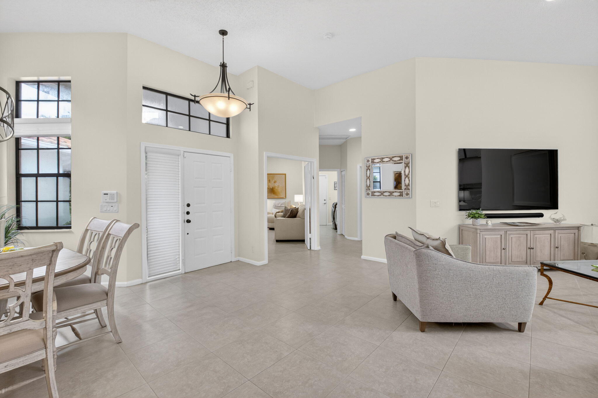 2462 Northwest 63rd Street Boca Raton, FL 33496 - Photo 3 of 41 a living room with furniture and a flat screen tv
