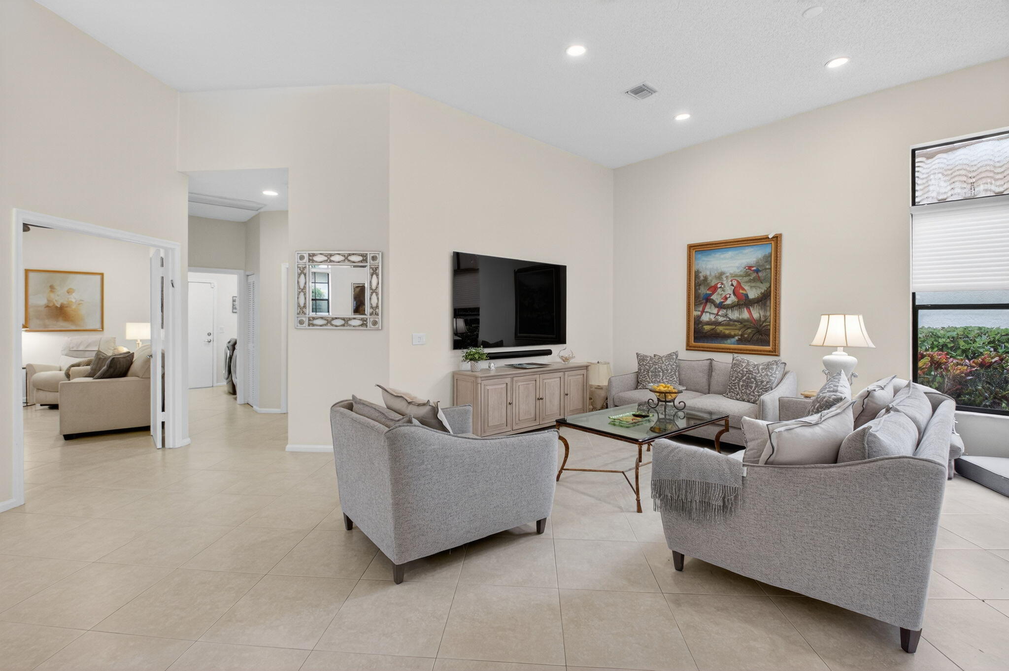 2462 Northwest 63rd Street Boca Raton, FL 33496 - Photo 4 of 41 a living room with furniture and a flat screen tv