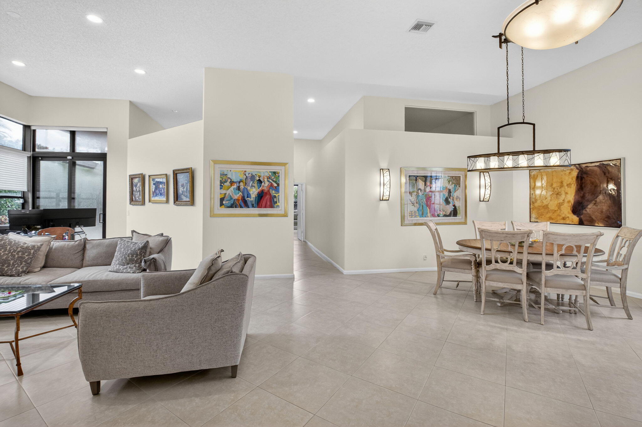 2462 Northwest 63rd Street Boca Raton, FL 33496 - Photo 7 of 41 a living room with furniture kitchen view and a chandelier