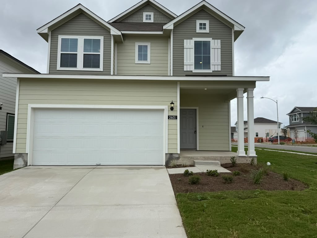 2601 Foss Road Manor, TX 78653 - Photo 1 of 40 Classic horizontal siding and shuttered windows define this two-story exterior featuring an attached two-car garage.