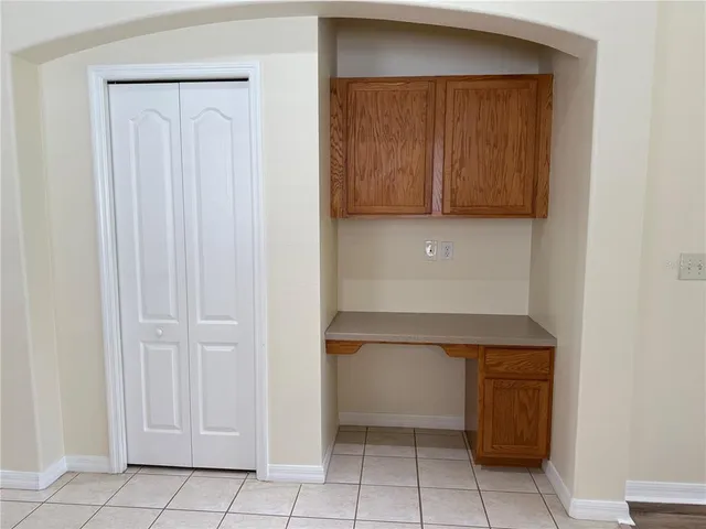 a kitchen with white cabinets and a sink