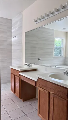a spacious bathroom with a sink and a mirror