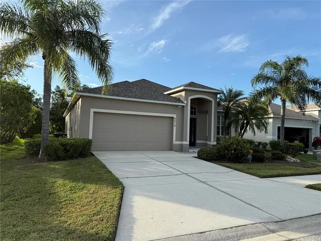 a front view of a house with a garden and yard