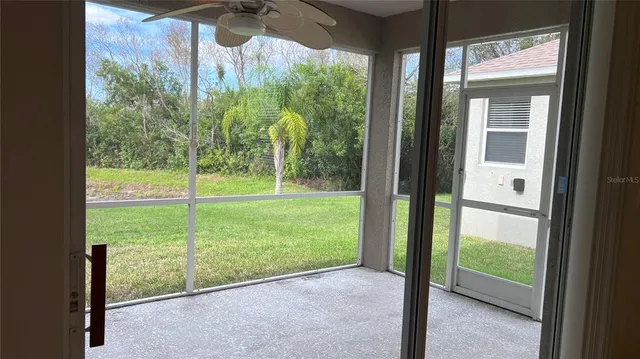 a view of backyard with large trees and plants