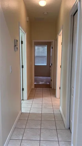 a view of a hallway with a door and entryway