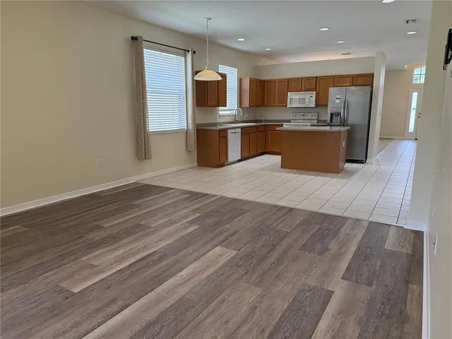 a open kitchen with stainless steel appliances granite countertop a stove and a sink