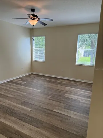 a view of room with window and ceiling fan