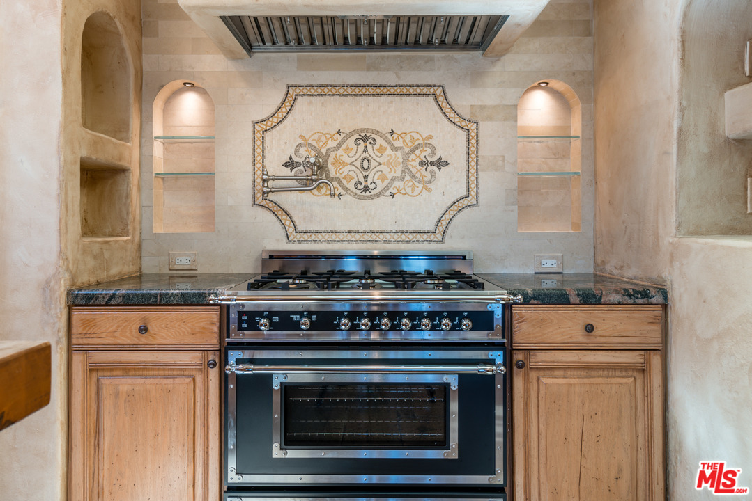 22102 Pacific Coast Highway Malibu, CA 90265 - Photo 16 of 36 a stove top oven sitting inside of a kitchen