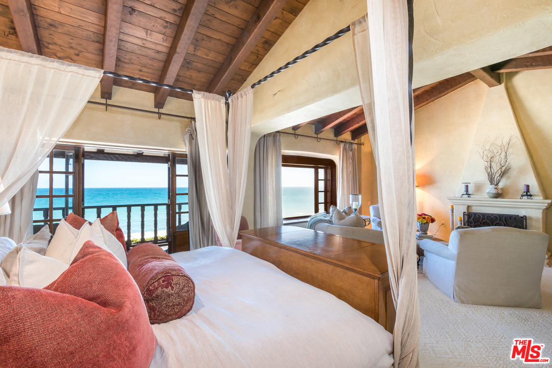 22102 Pacific Coast Highway Malibu, CA 90265 - Photo 21 of 36 a bedroom with furniture and a large window