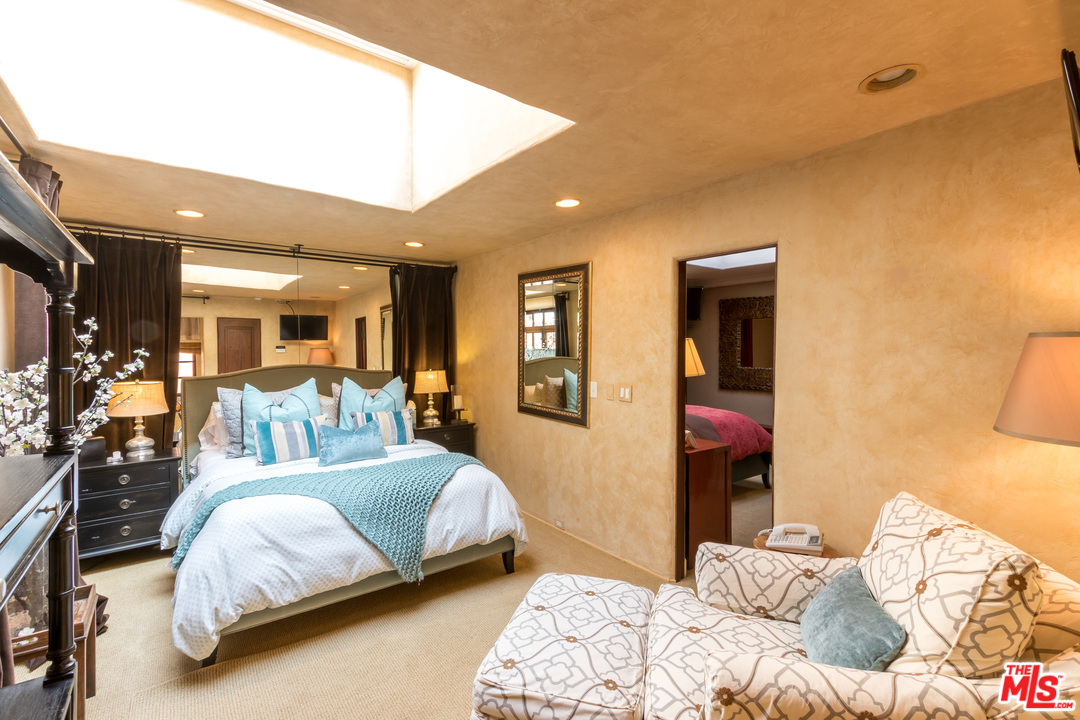 22102 Pacific Coast Highway Malibu, CA 90265 - Photo 27 of 36 a bedroom with a bed and a large mirror