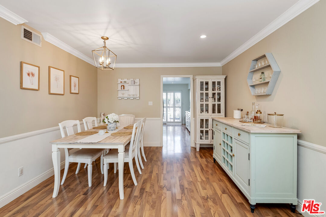 4443 Saugus Avenue, Unit 3 Sherman Oaks, CA 91403 - Photo 11 of 35 a view of a dining room with furniture window and wooden floor