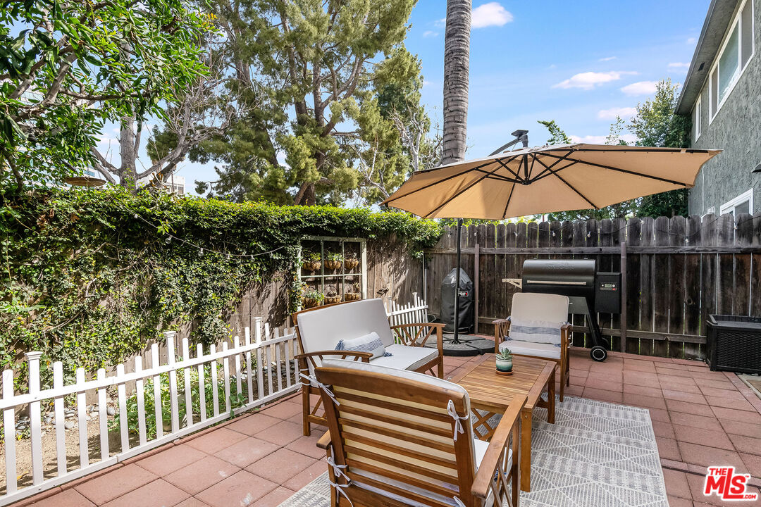 4443 Saugus Avenue, Unit 3 Sherman Oaks, CA 91403 - Photo 16 of 35 a view of backyard with seating space and wooden fence