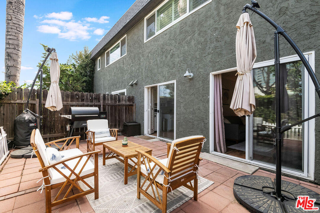4443 Saugus Avenue, Unit 3 Sherman Oaks, CA 91403 - Photo 17 of 35 a backyard of a house with barbeque oven table and chairs