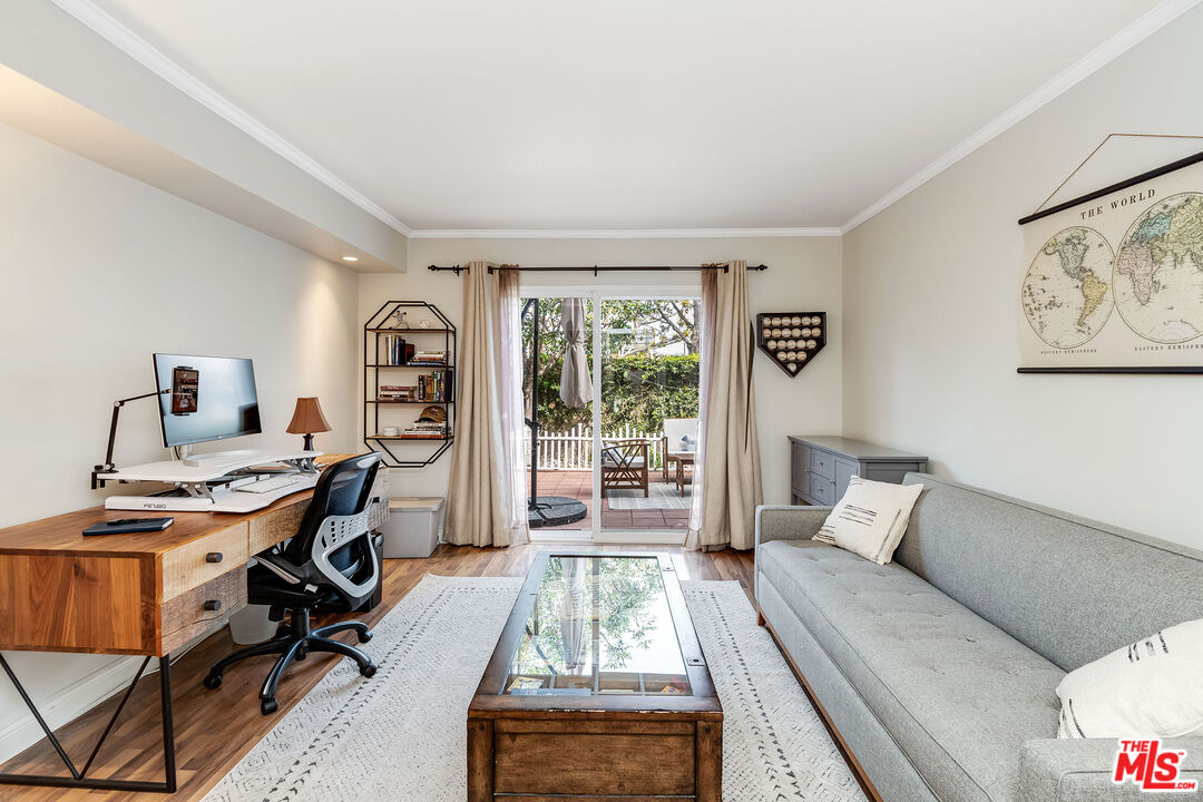 4443 Saugus Avenue, Unit 3 Sherman Oaks, CA 91403 - Photo 19 of 35 a living room with furniture fireplace and a large window