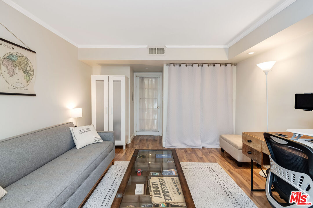4443 Saugus Avenue, Unit 3 Sherman Oaks, CA 91403 - Photo 20 of 35 a living room with a couch and a rug