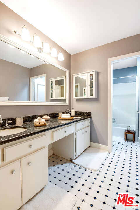 4443 Saugus Avenue, Unit 3 Sherman Oaks, CA 91403 - Photo 28 of 35 a large white kitchen with granite countertop a sink