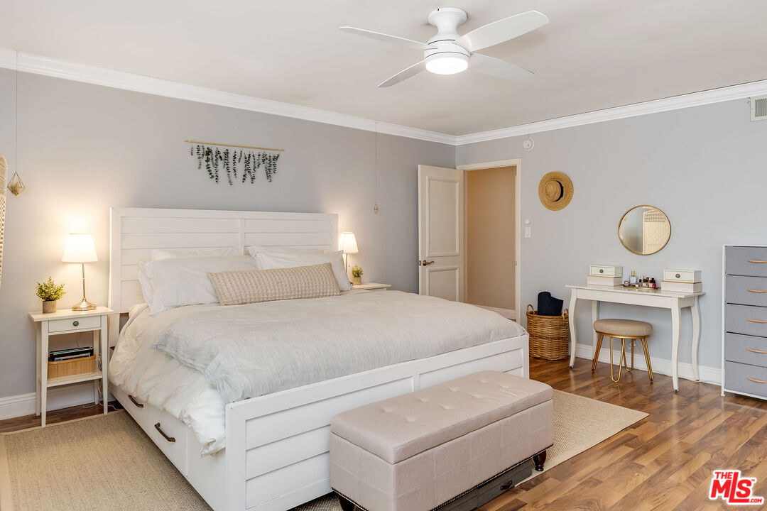 4443 Saugus Avenue, Unit 3 Sherman Oaks, CA 91403 - Photo 30 of 35 a bedroom with a bed and a chandelier