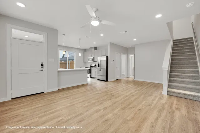 a view of an empty room with a kitchen