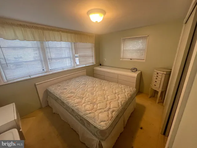 a bed sitting in a room next to a window