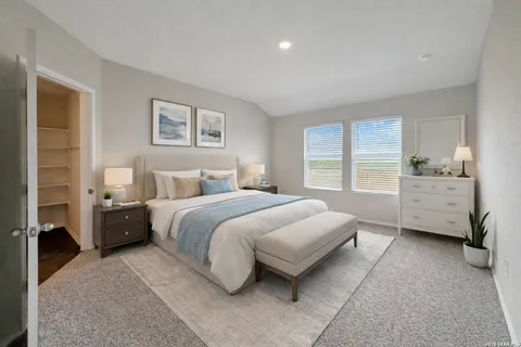 a bedroom with a bed and a couch