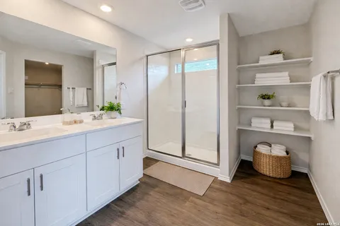 a bathroom with a double vanity sink and a mirror