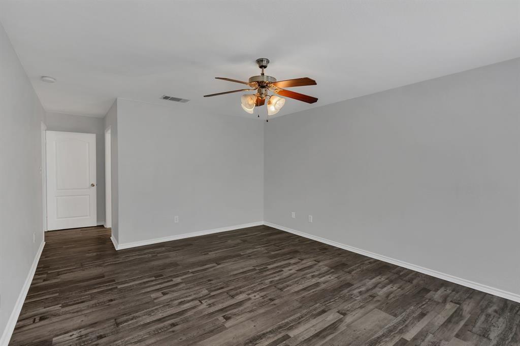 711 Parkplace Ridge Princeton, TX 75407 - Photo 11 of 15 a view of a room with wooden floor and a ceiling fan