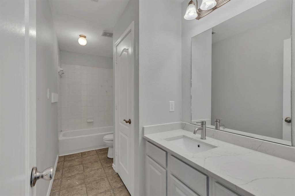711 Parkplace Ridge Princeton, TX 75407 - Photo 12 of 15 a bathroom with a sink a toilet and shower