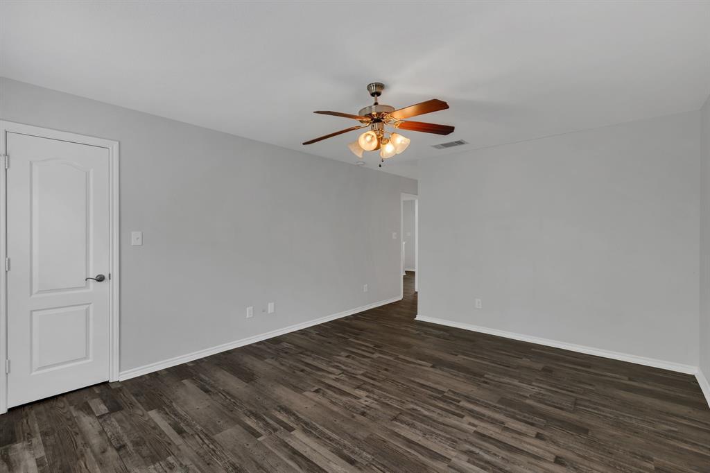 711 Parkplace Ridge Princeton, TX 75407 - Photo 13 of 15 a view of an empty room with wooden floor
