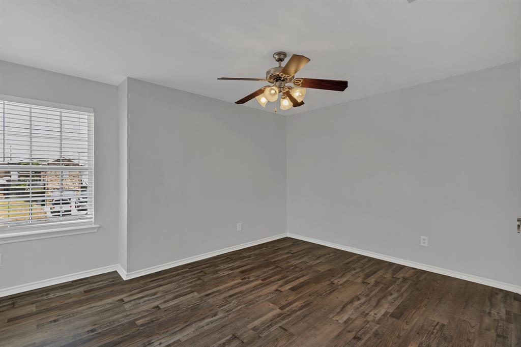 711 Parkplace Ridge Princeton, TX 75407 - Photo 14 of 15 a view of empty room with wooden floor and fan