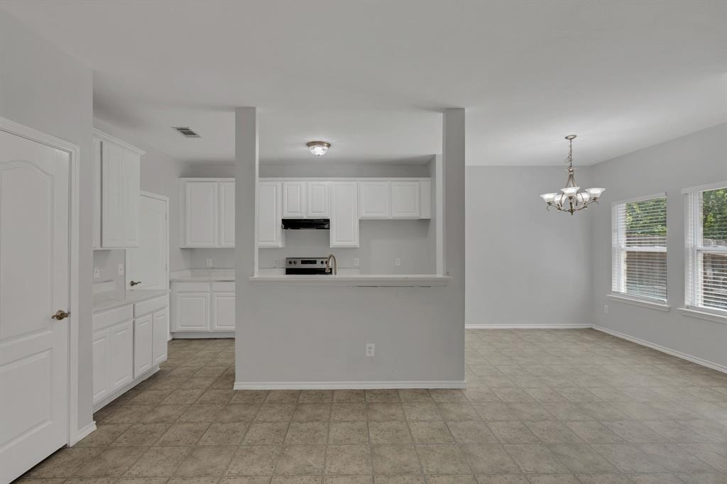711 Parkplace Ridge Princeton, TX 75407 - Photo 4 of 15 a large white kitchen with cabinets