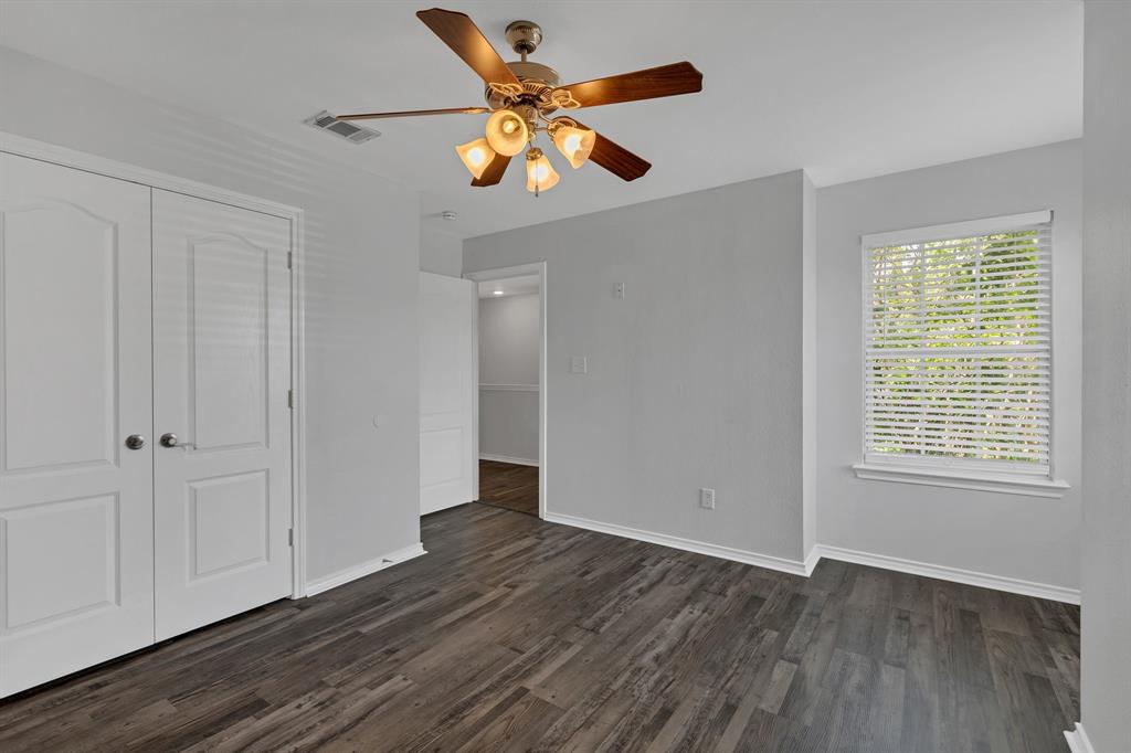 711 Parkplace Ridge Princeton, TX 75407 - Photo 9 of 15 an empty room with wooden floor and windows