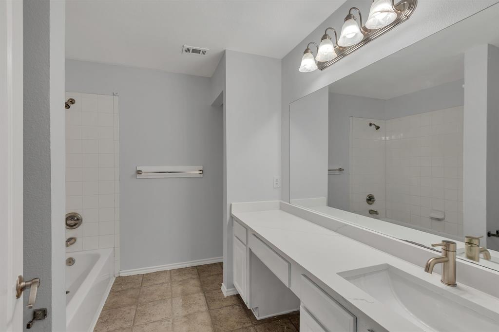 711 Parkplace Ridge Princeton, TX 75407 - Photo 10 of 15 a bathroom with a sink a vanity and a mirror