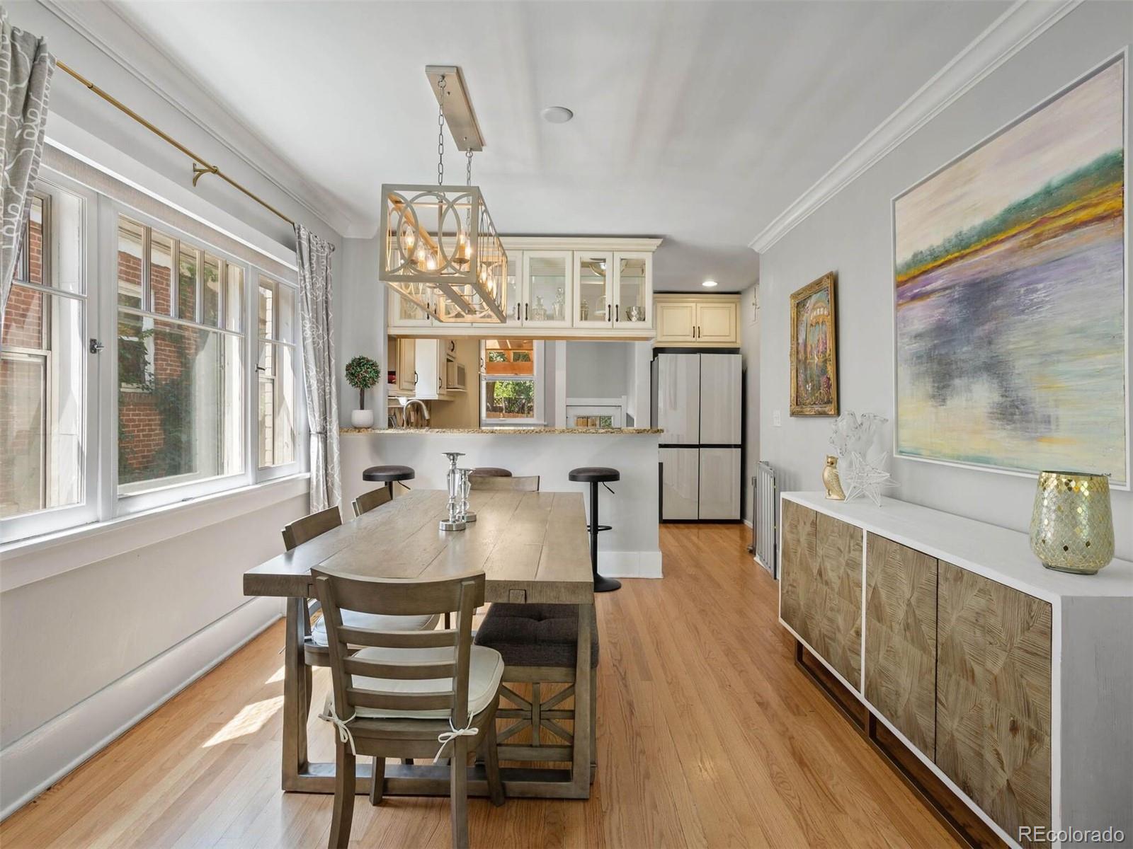 643 Jackson Street Denver, CO 80206 - Photo 11 of 40 a view of a dining room with furniture and a window