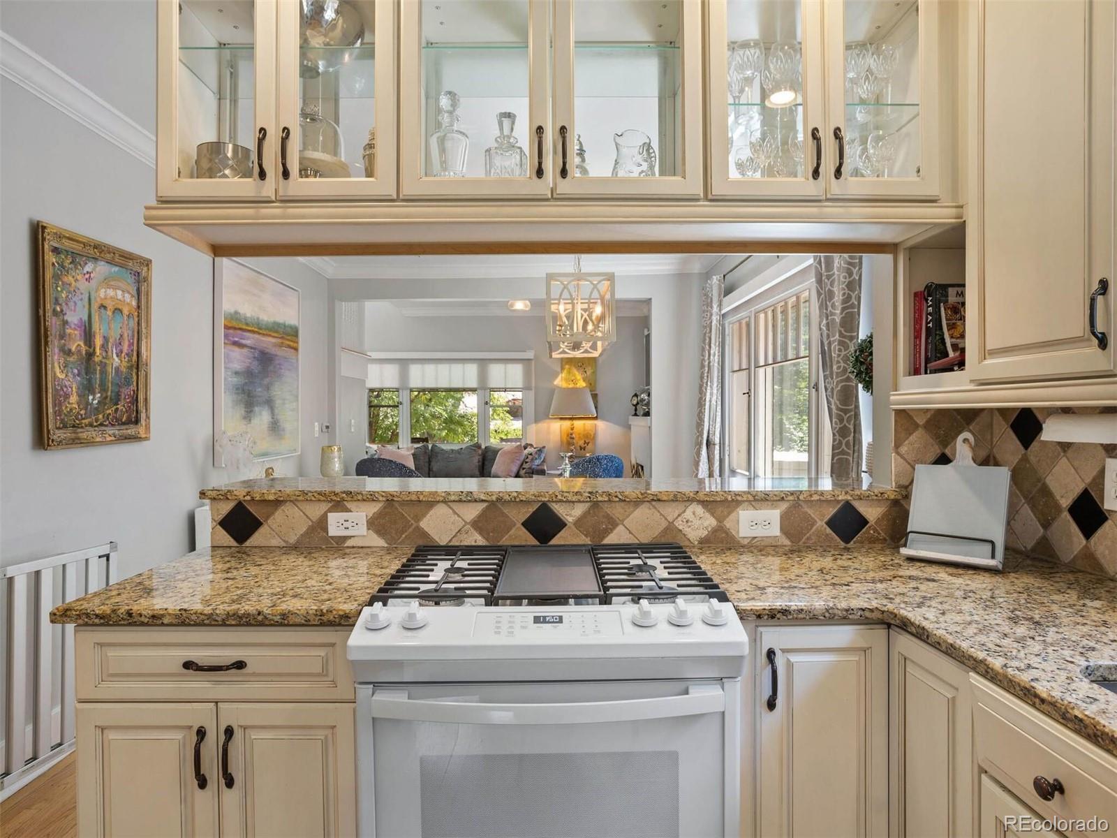 643 Jackson Street Denver, CO 80206 - Photo 16 of 40 a kitchen with granite countertop a sink stove and cabinets