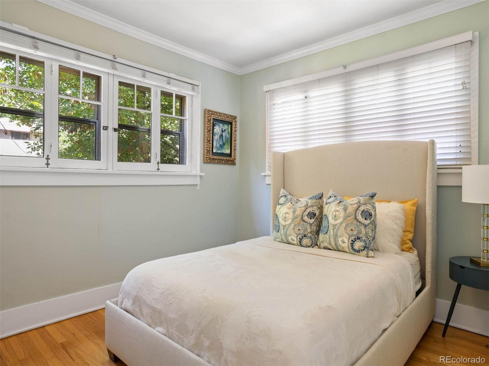 643 Jackson Street Denver, CO 80206 - Photo 19 of 40 a bedroom with a large bed and a window