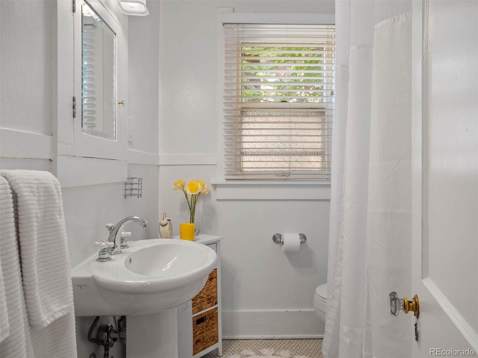 643 Jackson Street Denver, CO 80206 - Photo 20 of 40 a bathroom with a sink and a window