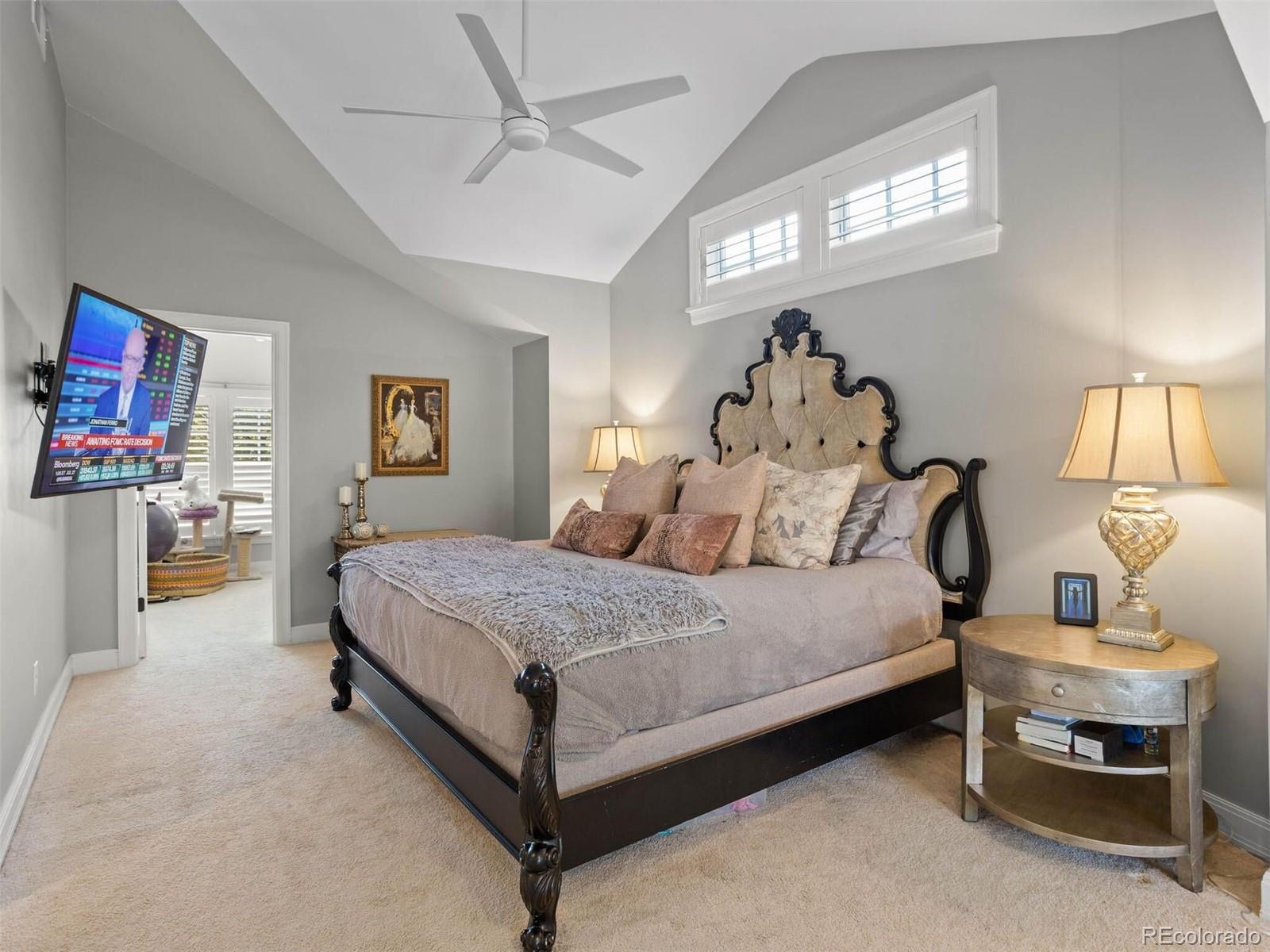 643 Jackson Street Denver, CO 80206 - Photo 24 of 40 a spacious bedroom with a bed and a chandelier