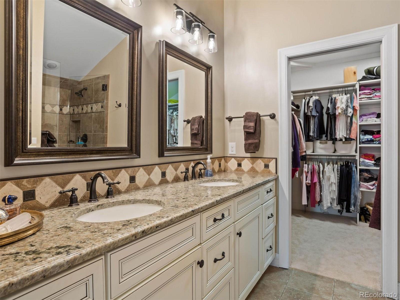 643 Jackson Street Denver, CO 80206 - Photo 27 of 40 a bathroom with double vanity sinks a vanity and a mirror