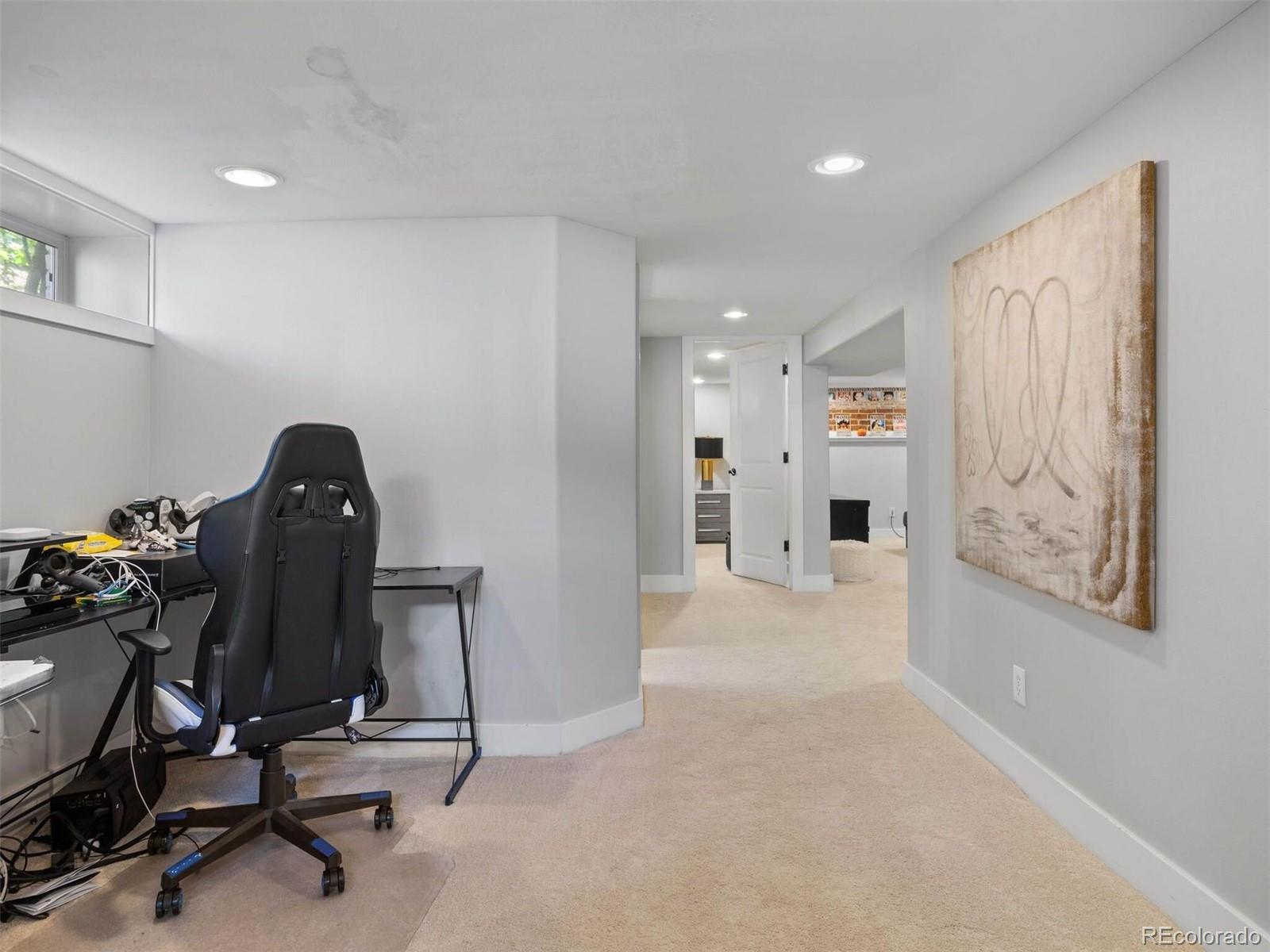643 Jackson Street Denver, CO 80206 - Photo 31 of 40 a view of a workspace with furniture and gym equipment