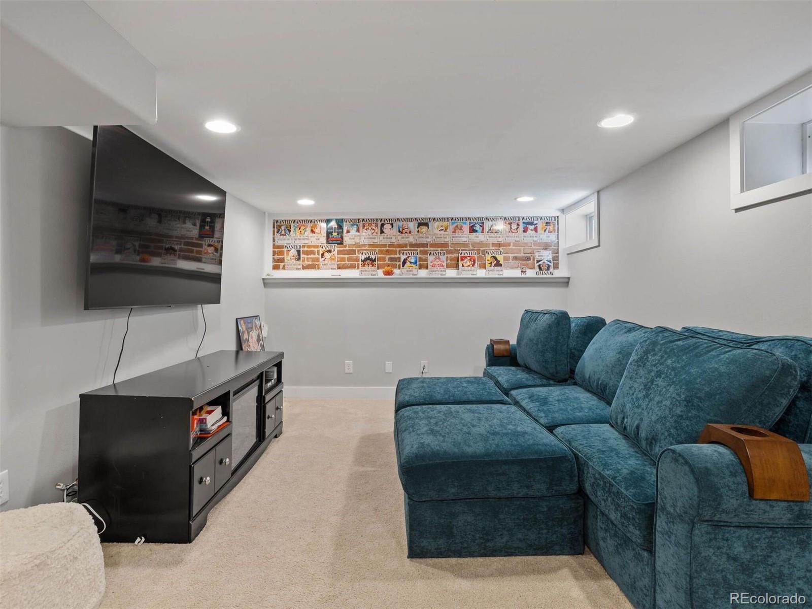 643 Jackson Street Denver, CO 80206 - Photo 32 of 40 a living room with furniture and a flat screen tv